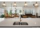 Open concept kitchen with island, stainless steel sink and view into living area at 386 Tupelo Lake Dr, Summerville, SC 29486