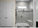 Large walk-in shower with gray tile, glass door, and built-in seat at 386 Tupelo Lake Dr, Summerville, SC 29486