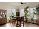 Bright sunroom with many plants, a small table and chairs, and hardwood floors at 386 Tupelo Lake Dr, Summerville, SC 29486