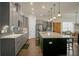 Spacious kitchen with gray cabinets, quartz countertops, and a large island at 386 Tupelo Lake Dr, Summerville, SC 29486