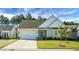 Beige two-story house with gray roof, attached garage, and blue door at 386 Tupelo Lake Dr, Summerville, SC 29486