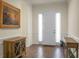Entry hall with hardwood floors, consoles, and white door at 386 Tupelo Lake Dr, Summerville, SC 29486