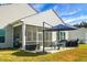Screened porch and patio area with table, chairs, and umbrella at 386 Tupelo Lake Dr, Summerville, SC 29486