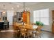 Bright dining room features a large wooden table with six chairs, hardwood floors and large window at 386 Tupelo Lake Dr, Summerville, SC 29486