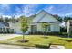 Beige two-story house with gray roof, attached garage, and landscaping at 386 Tupelo Lake Dr, Summerville, SC 29486