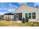 Relaxing backyard patio with screened porch, umbrella, and grill at 386 Tupelo Lake Dr, Summerville, SC 29486