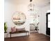 Bright entryway with hardwood floors, a bench, and a large round mirror at 366 Wappoo Trace Ln, Summerville, SC 29486