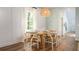 Bright dining room with wooden table, chairs, and large window at 201 Dean Hall Ave, Moncks Corner, SC 29461