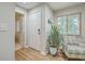 Bright entryway with white door, wood floors, and a comfy chair at 266 Alexandra Dr # 15, Mount Pleasant, SC 29464
