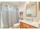 Bathroom with grey shower curtain and wood vanity at 266 Alexandra Dr # 15, Mount Pleasant, SC 29464