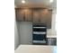 Double oven and modern gray kitchen cabinets at 741 Blue Iris Way, Summerville, SC 29486