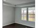 Bright and airy living room with hardwood flooring and large windows at 741 Blue Iris Way, Summerville, SC 29486