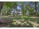 Spacious backyard with mature trees and grassy lawn at 5 Avon Ct, Charleston, SC 29407