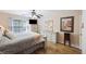 Well-lit bedroom with a full bed, dresser, and hardwood floors at 5 Avon Ct, Charleston, SC 29407