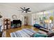Spacious living room with hardwood floors, fireplace and ceiling fan at 5 Avon Ct, Charleston, SC 29407