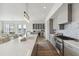 Modern kitchen with gray cabinets, quartz countertops, and stainless steel appliances at 301 Longshore St # 441, Charleston, SC 29492
