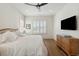 Main bedroom with hardwood floors, plantation shutters and neutral decor at 301 Longshore St # 441, Charleston, SC 29492