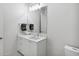 Simple bathroom with a white vanity, marble countertop, and a large mirror at 301 Longshore St # 441, Charleston, SC 29492