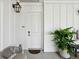 Apartment entry with white door, potted plant, and seating at 301 Longshore St # 441, Charleston, SC 29492