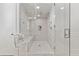 Large walk-in shower with marble tile, built-in seat and dual shower heads at 301 Longshore St # 441, Charleston, SC 29492