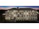 Evening view of a three-story building with balconies and ground floor retail at 301 Longshore St # 441, Charleston, SC 29492