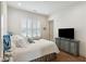 Comfortable bedroom with a queen bed, white shutters, and a vintage media cabinet at 301 Longshore St # 441, Charleston, SC 29492