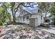 White house with storage shed and large oak trees at 119 E Indian Ave # 1, Folly Beach, SC 29439