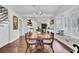 Bright dining room with a charming table, built-in window seat, and hardwood floors at 119 E Indian Ave # 1, Folly Beach, SC 29439