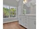 Bathroom with white vanity, brown tile floor, and large window at 361 Wappoo Trace Ln, Summerville, SC 29486