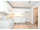 White kitchen with modern appliances and wood-look floors at 1910 Tropicana Rd # 9-B, North Charleston, SC 29406