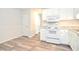 White kitchen with modern appliances and wood-look floors at 1910 Tropicana Rd # 9-B, North Charleston, SC 29406