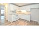 White kitchen with modern appliances and wood-look floors at 1910 Tropicana Rd # 9-B, North Charleston, SC 29406