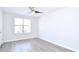 Bright bedroom with ceiling fan, large window, and grey wood-look flooring at 1910 Tropicana Rd # 9-B, North Charleston, SC 29406