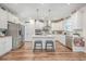 Modern kitchen with white cabinets, stainless steel appliances, and an island with seating at 612 S Pointe Blvd, Summerville, SC 29483