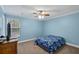 Bedroom with a TV, dresser and blue floral bedding at 316 Bay Village Ln, Moncks Corner, SC 29461