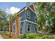 Two-story home with gray siding, wood accents, and landscaping at 1056 Wharf Indigo Pl, Mount Pleasant, SC 29464