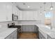 Modern kitchen with white and gray cabinets and a farmhouse sink at 425 Grove End Rd, Moncks Corner, SC 29461