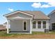 Gray house with covered patio, providing a shaded outdoor space at 425 Grove End Rd, Moncks Corner, SC 29461