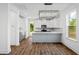 Modern kitchen with white cabinets, gray island, and stainless steel appliances at 425 Grove End Rd, Moncks Corner, SC 29461