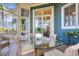 Relaxing screened porch with glass-top dining table and wicker chairs at 11 Falcon Point Rd, Kiawah Island, SC 29455