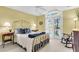 Charming bedroom with a gold metal bed frame and private balcony access at 11 Falcon Point Rd, Kiawah Island, SC 29455