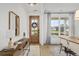 Inviting entryway with wooden console table, mirror, and a large window at 416 Grove End Rd, Moncks Corner, SC 29461