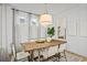 Bright dining room with a rustic wooden table and light-filled windows at 416 Grove End Rd, Moncks Corner, SC 29461