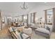 Open living room with vaulted ceiling, comfy seating, and adjacent dining area at 416 Grove End Rd, Moncks Corner, SC 29461