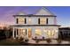 Two story white farmhouse style home with black shutters and a welcoming front porch at 416 Grove End Rd, Moncks Corner, SC 29461