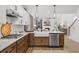 White and wood kitchen with farmhouse sink, stainless steel appliances, and an island at 416 Grove End Rd, Moncks Corner, SC 29461