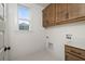Bright laundry room with wood cabinets and hexagon tile flooring at 416 Grove End Rd, Moncks Corner, SC 29461