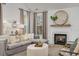 Living room fireplace with a marble surround and a large mirror above at 416 Grove End Rd, Moncks Corner, SC 29461