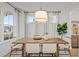 Elegant dining room with a rustic wooden table and light-filled windows at 416 Grove End Rd, Moncks Corner, SC 29461