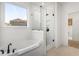 Bathroom features a soaking tub, walk-in shower, and large window at 416 Grove End Rd, Moncks Corner, SC 29461